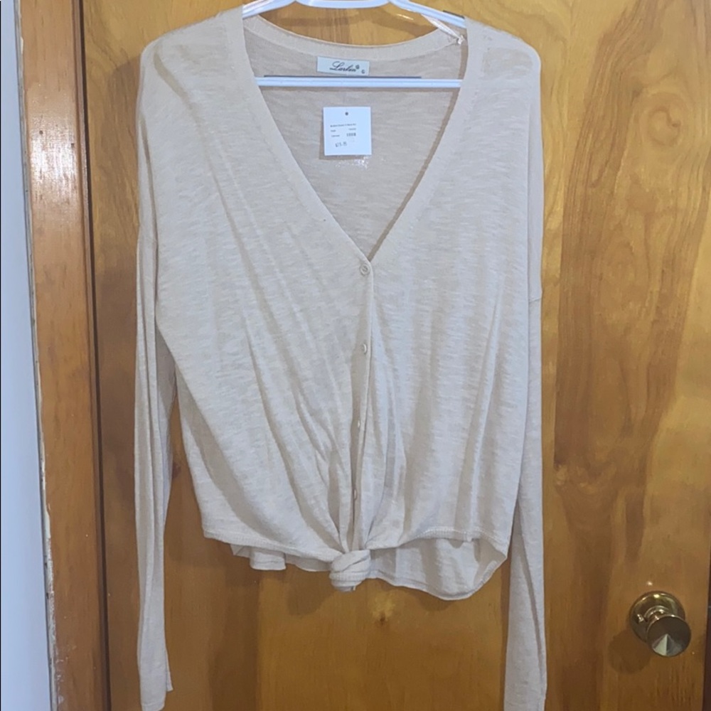 Oatmeal color button down V neck knit sweater.